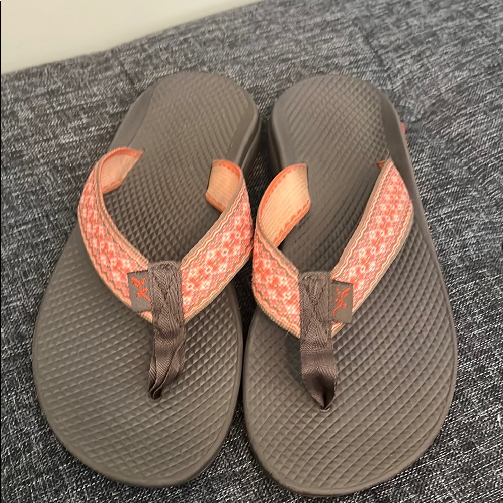 Brown and orange Chaco flip flops.